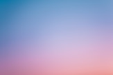 a pink and blue sky with a few clouds
