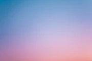 a pink and blue sky with a few clouds