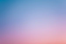 a pink and blue sky with a few clouds