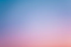 a pink and blue sky with a few clouds