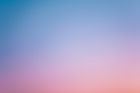 a pink and blue sky with a few clouds