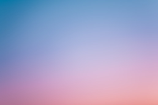 a pink and blue sky with a few clouds