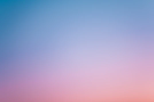 a pink and blue sky with a few clouds