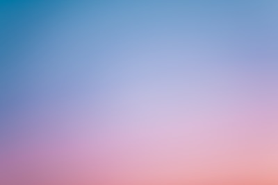 a pink and blue sky with a few clouds