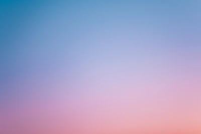 a pink and blue sky with a few clouds
