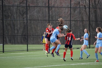 A vibrant soccer match scene with players in blue and red jerseys competing passionately on a sunny field.