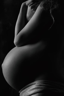 garyscale photography of pregnant woman
