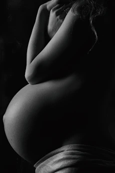 garyscale photography of pregnant woman