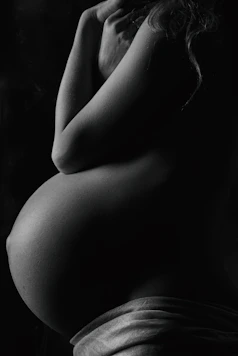 garyscale photography of pregnant woman