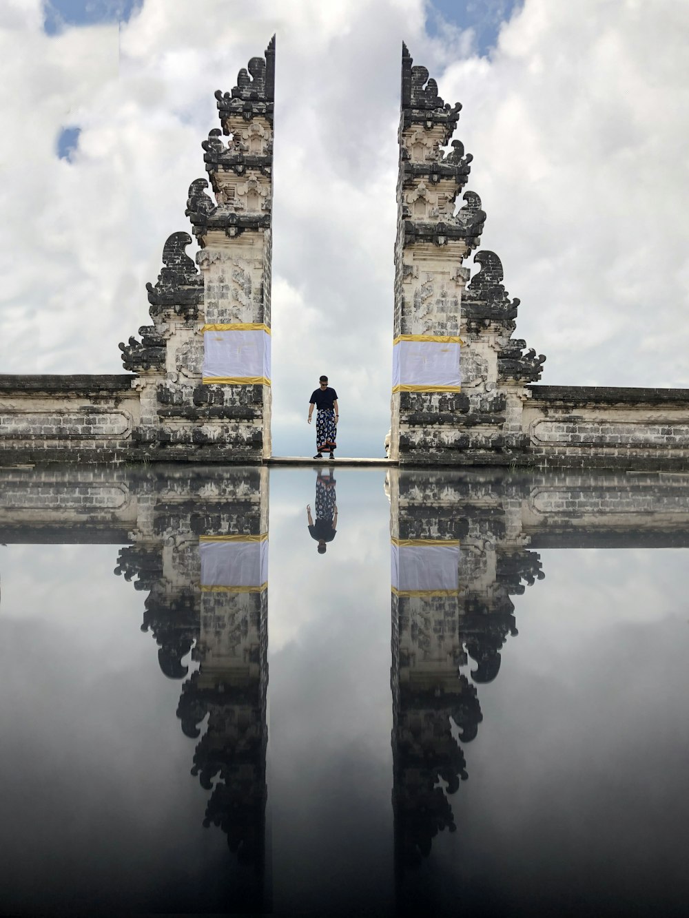 man standing between white hallway