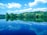 A serene landscape with a calm lake reflecting the sky, symbolizing peace and harmony.