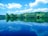 A serene landscape with a calm lake reflecting the sky, symbolizing peace and harmony.