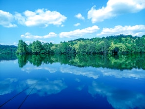 A serene landscape with a tranquil lake reflecting the sky.