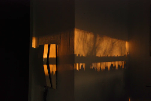 Still frame of a vertical branded content video featuring vibrant warm light accents against a charcoal background.
