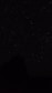 the night sky with stars above a mountain