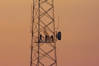 three people standing on crane tower