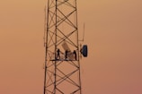 three people standing on crane tower