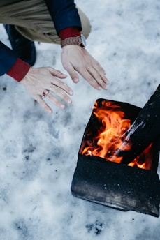 person warming hands on fire