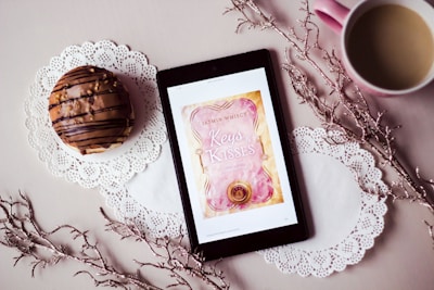 tablet showing Keys Kisses card between filled cup and dessert