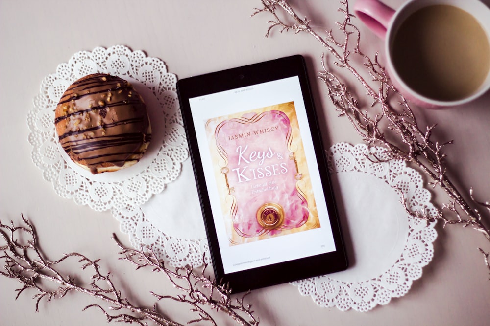 tablet showing Keys Kisses card between filled cup and dessert