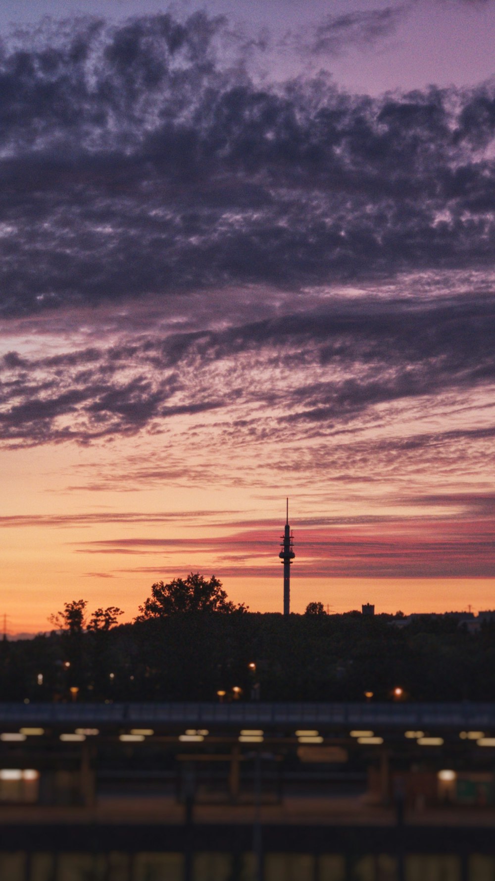 silhouette of tower under gray sky