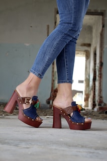 A model wearing stylish sustainable sandals in an outdoor setting.