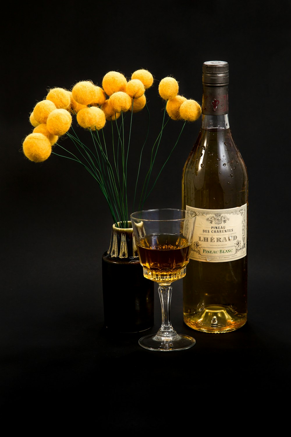 Lheraud blanc beside footed glass and yellow flower centerpiece