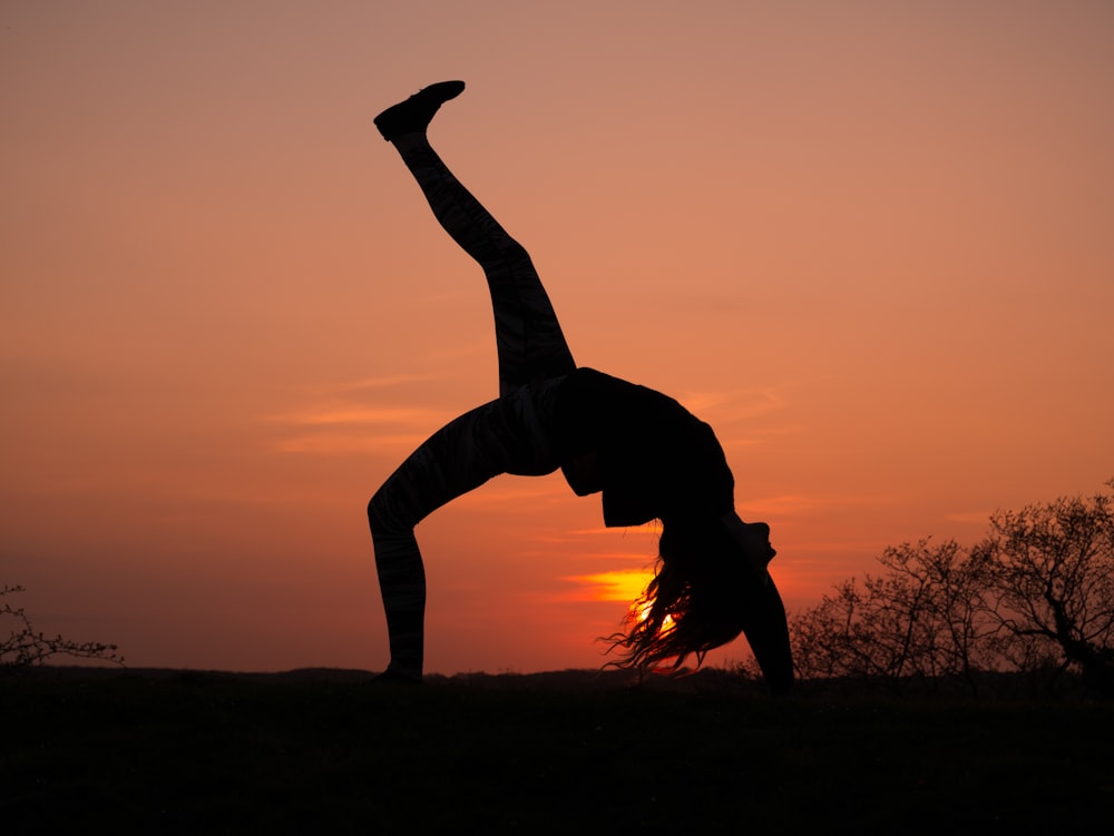 silhouette of person doing bending