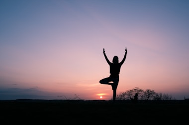 silhouette of person balancing using 1 foot