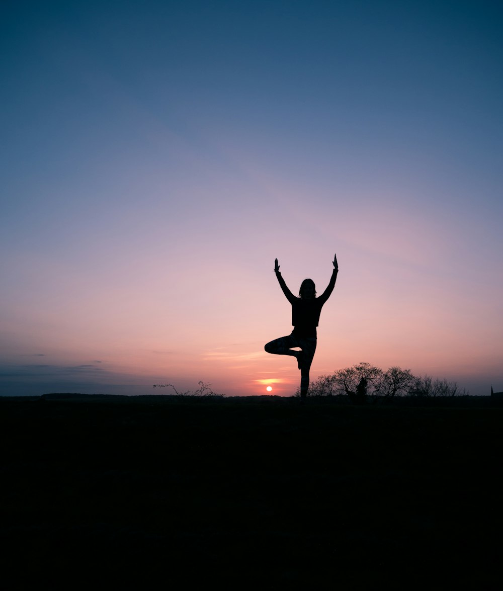 silhouette of person balancing using 1 foot