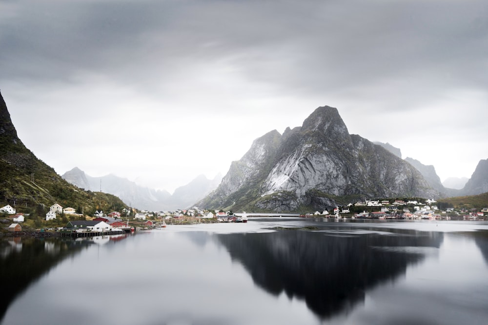 lake surrounded by houses and mountains