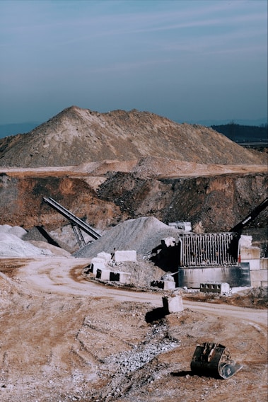 A panoramic view of Sadara Alkhalejiya Co's busy quarry site with heavy machinery moving aggregates.