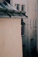 A narrow alley between two buildings, the light filtering down creating a calm, contemplative atmosphere.