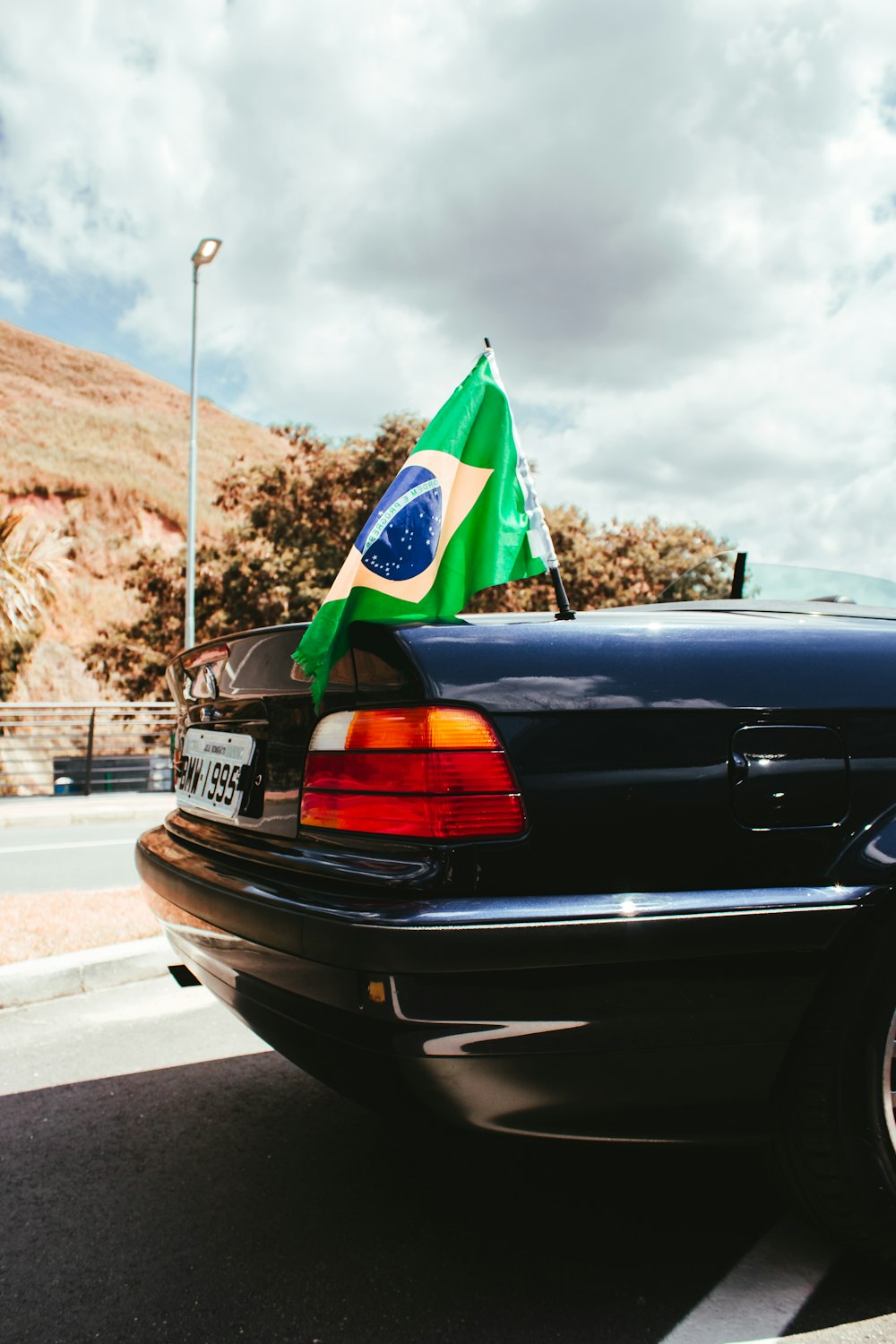Brazil flag on tail of blue car