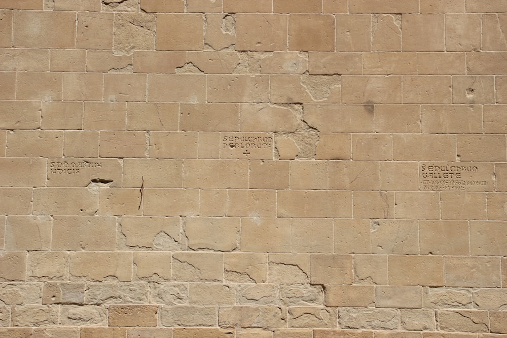 a stone wall with a clock on it