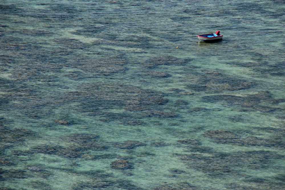 gray punt boat at middle of ocean