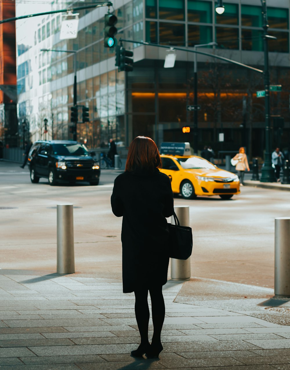 woman standing on sidewalk