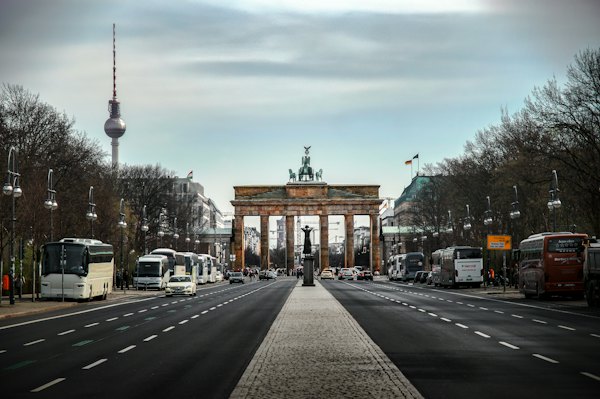 The Brandenburg Gate and the TV Tower in Berlin under a cloudy sky