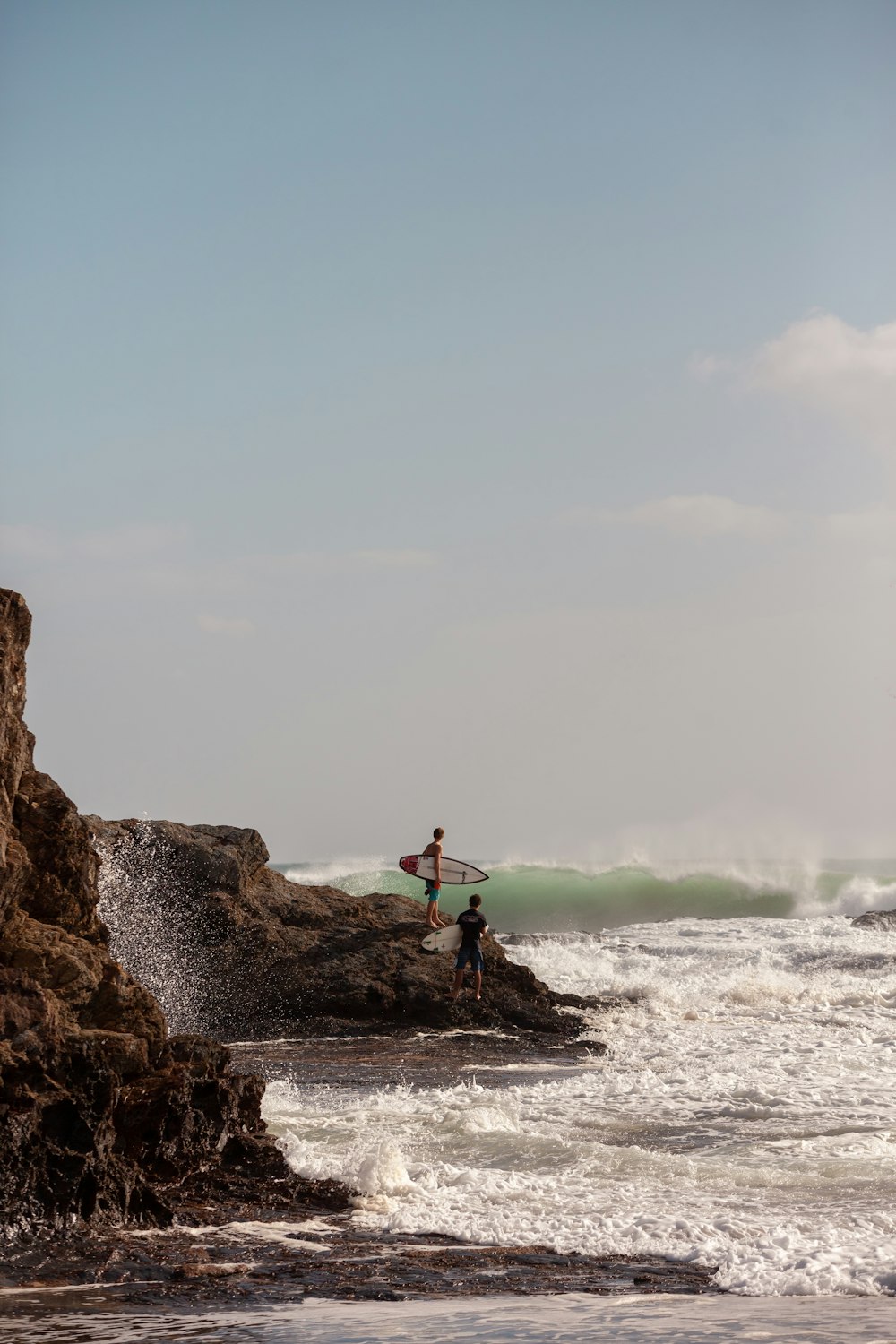 surfers on rock