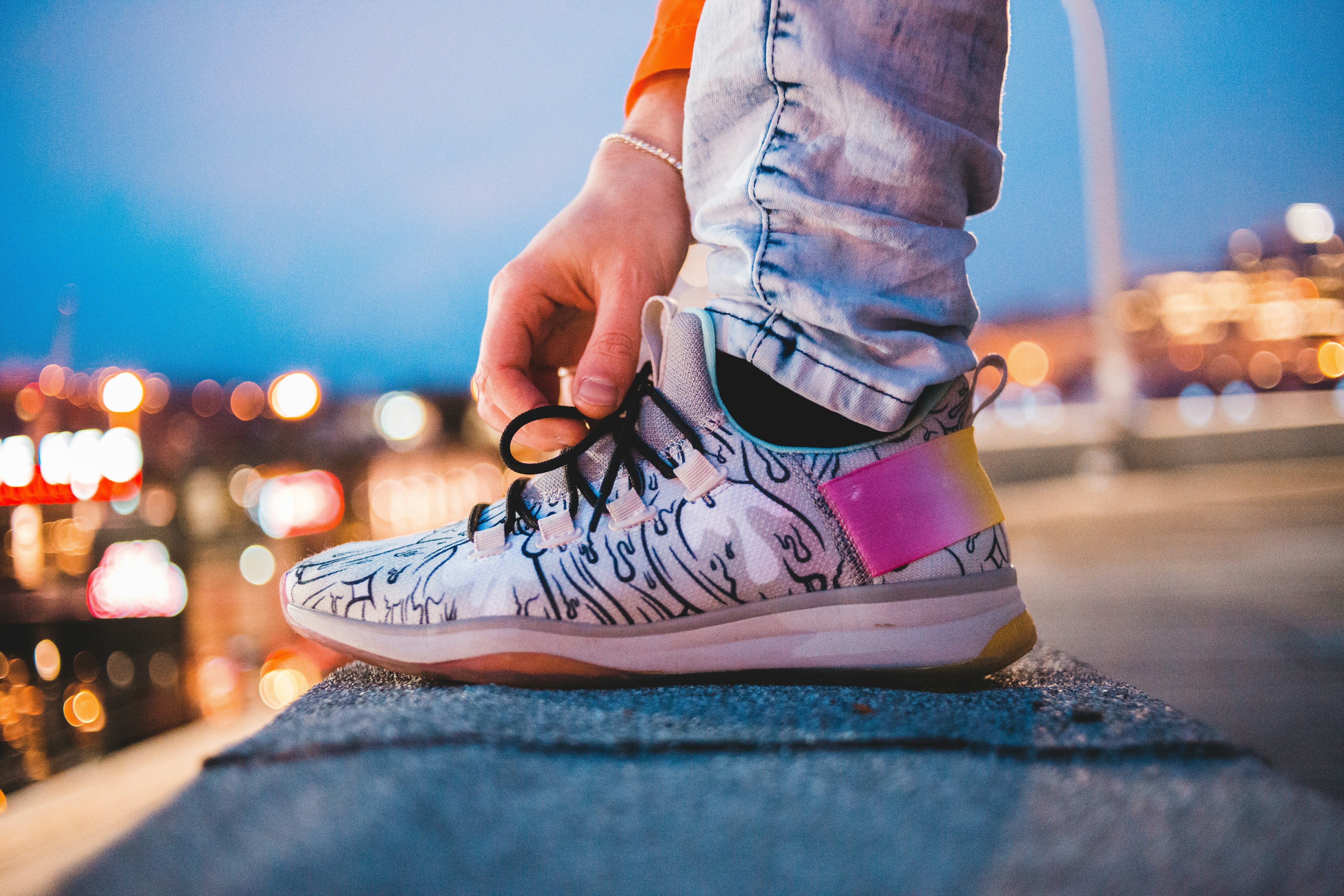 person reaching for shoe string