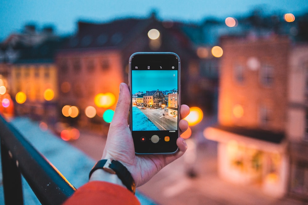 person taking photo of apartments