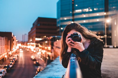 woman using black camera outdoors photography google meet background