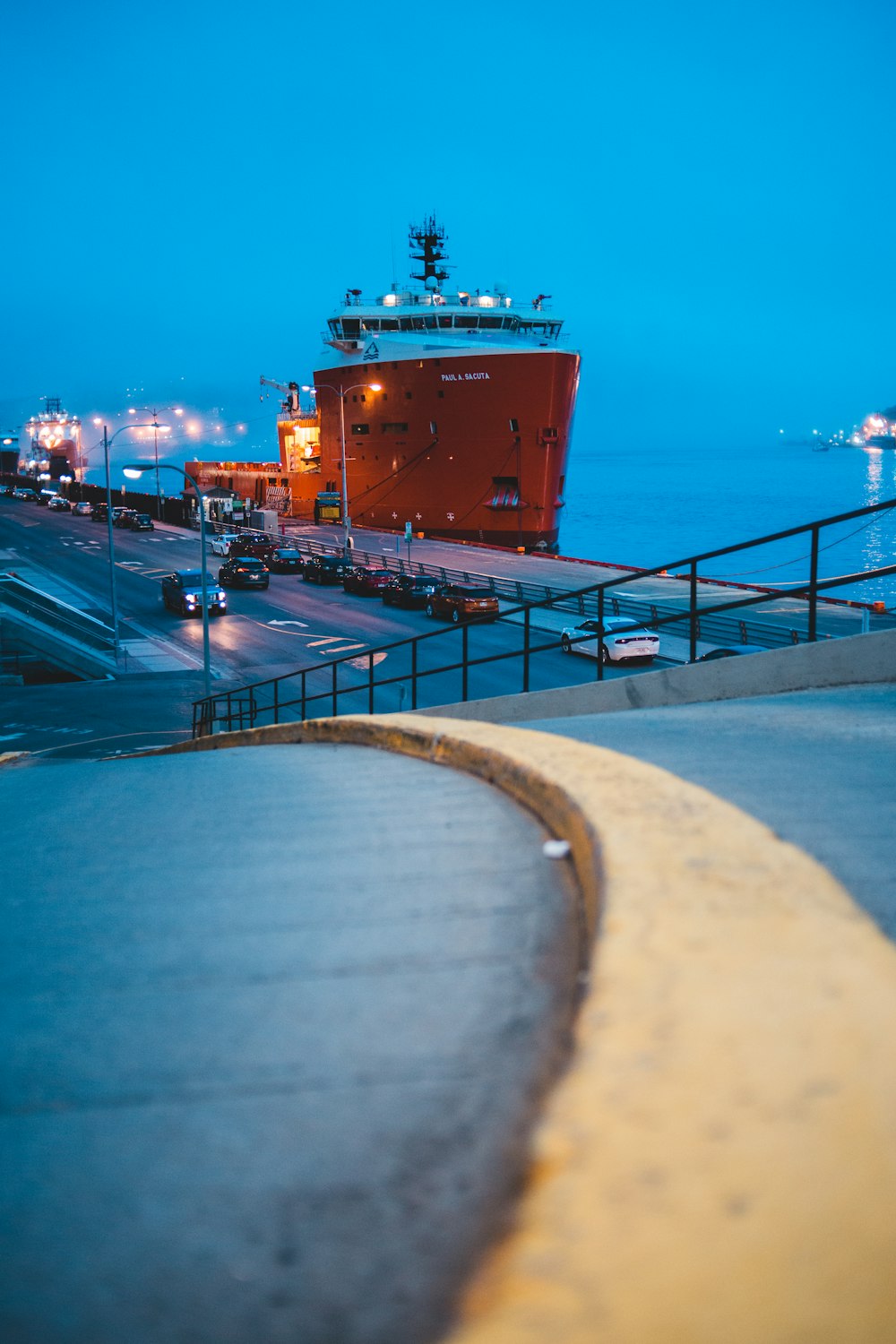 red and white shipping boat