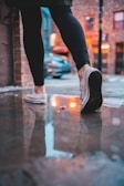 Model wearing sleek leggings on a bustling city street at dawn, capturing motion and energy.
