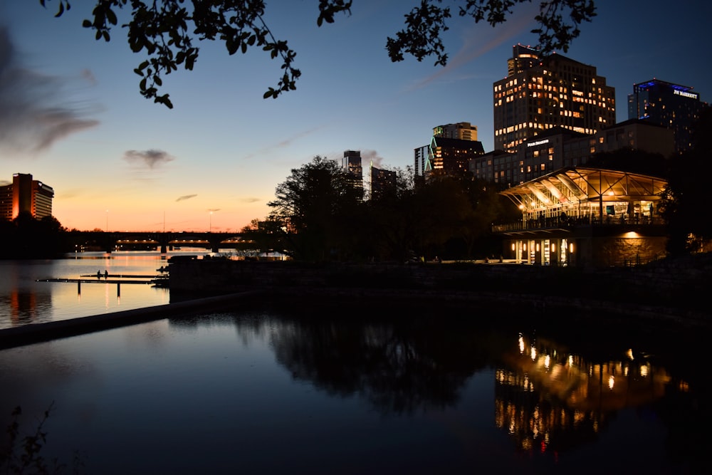 lighted buildings by body of water