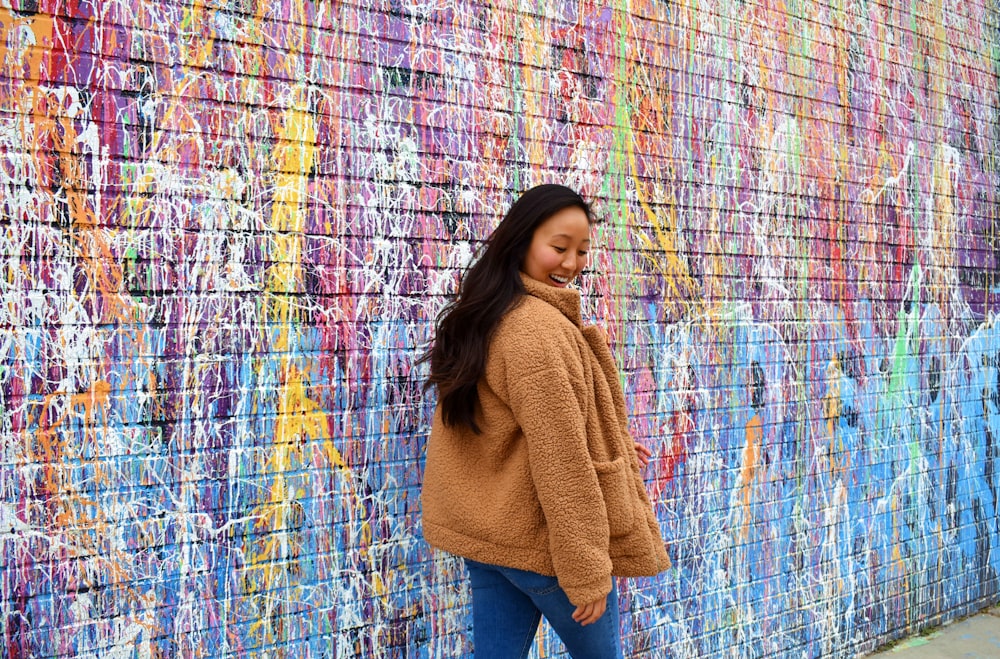 woman walking beside wall