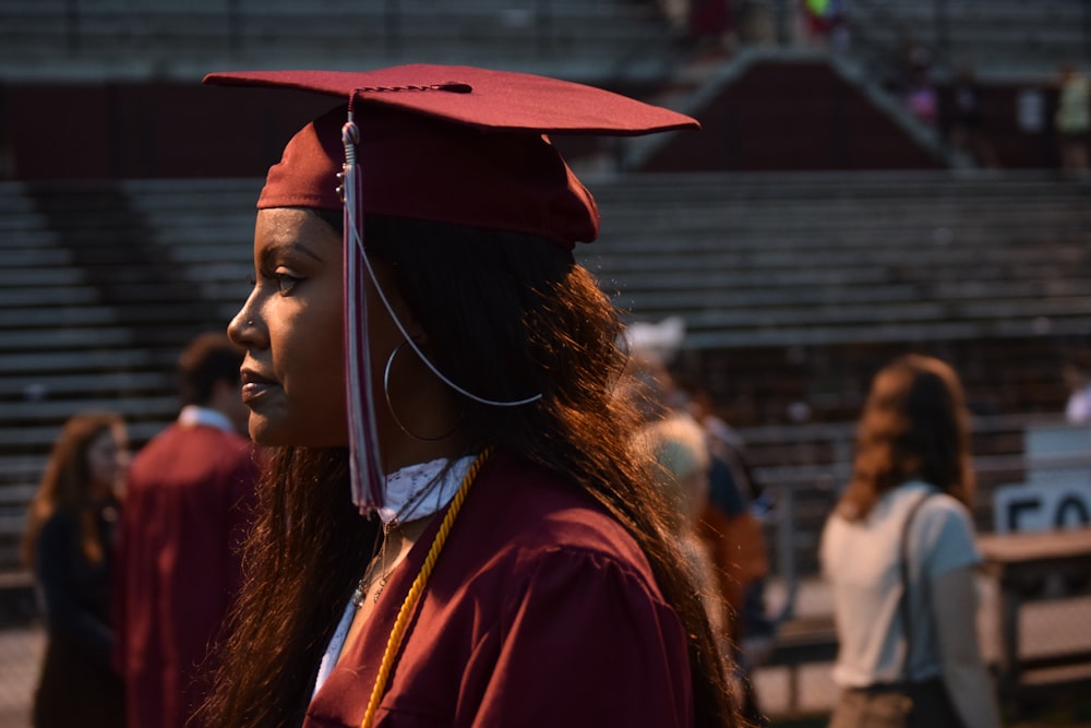 woman wearing red graduation cap