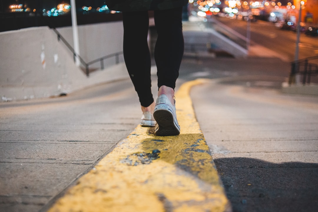 person walking on yellow painted road