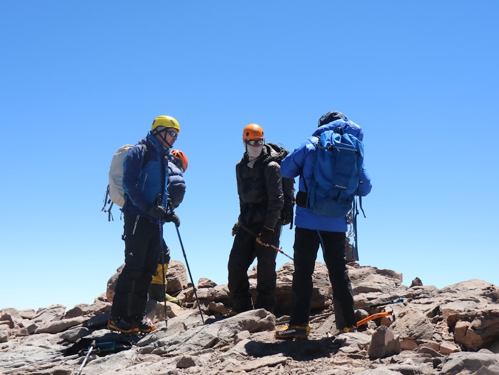 three trekkers during daytime