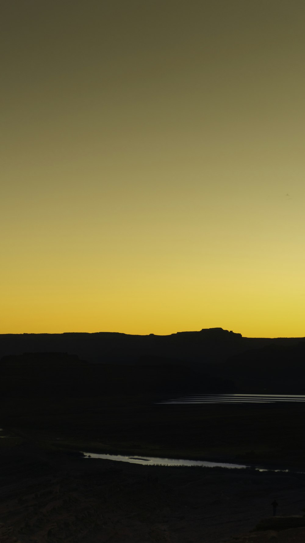 a plane flying in the sky over a body of water